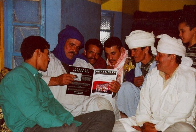Moroccan friends from Safsaf enjoying the February 2003 issue of Meteorite Magazine.