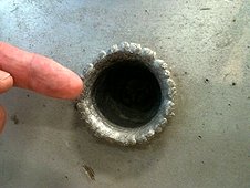 NASA - JSC Visit - Explosive crater produced in 1 inch thick aluminum metal.