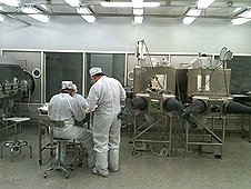 NASA - JSC Visit - Scientsts working inside the lunar sample vault.