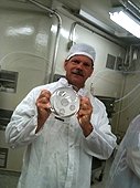 NASA - JSC Visit - Greg holding Acrylic dome with moon rock samples.