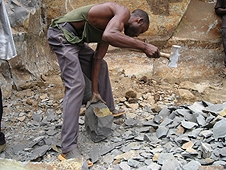 Thika, Kenya Expedition - Kenyan worker making rock blocks for house foundations.